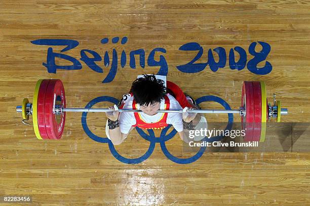 Liu Chunhong of China breaks the world record in the clean and jerk by lifting 158 kg in the women's 69kg weightlifting competition at the University...