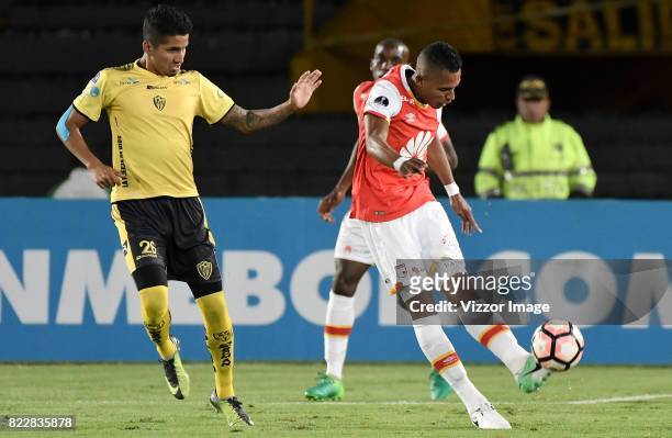 William Tesillo of Independiente Santa Fe fights for the ball with Joffre Escobar of Fuerza Amarilla during the match between Independiente Santa Fe...