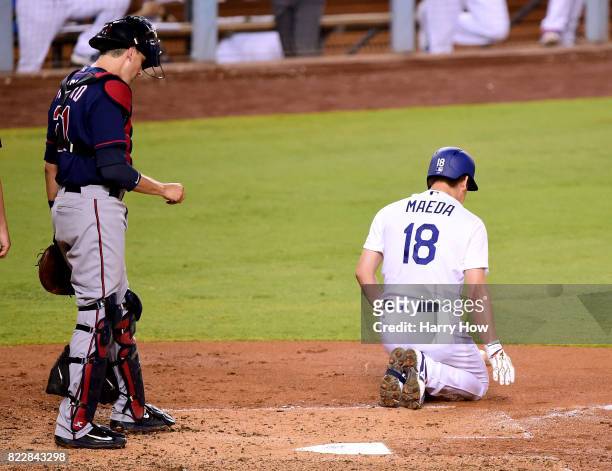 Kenta Maeda of the Los Angeles Dodgers reacts to an inside pitch in front of Jason Castro of the Minnesota Twins during the third inning at Dodger...