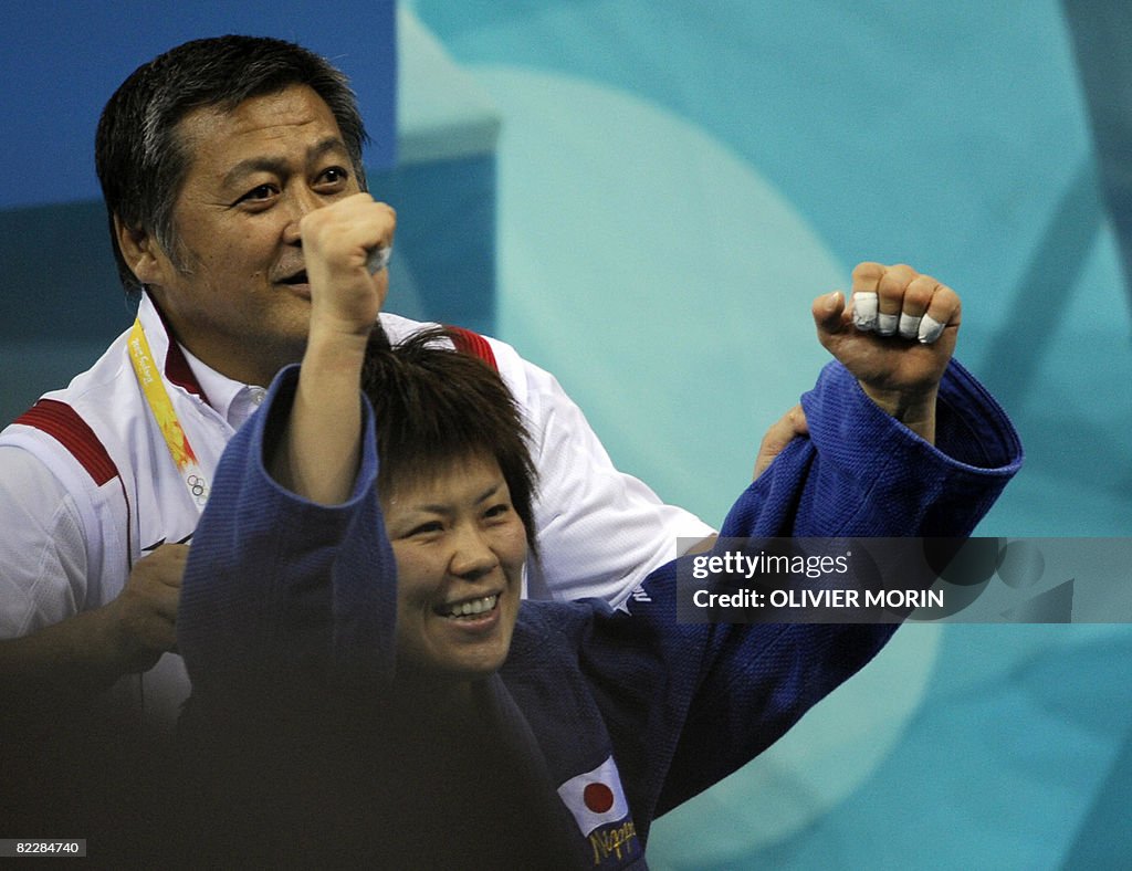 Japan's Masae Ueno jubilates with her co
