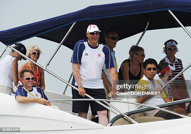 King Harald V of Norway laughs as he talks with skipper Peer Moberg of Norway in the Finn class as they wait for the start of the race at the 2008...