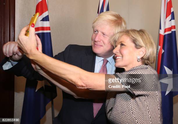 British Foreign Secretary Boris Johnson, left, has a "selfie" photo taken with Australian Foreign Minister Julie Bishop ahead of their bilateral...