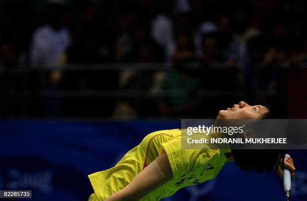 China's Lu Lan leans back to play a shot against Malaysia's Wong Mew Choo during their women's singles quarter-final badminton match for the 2008...