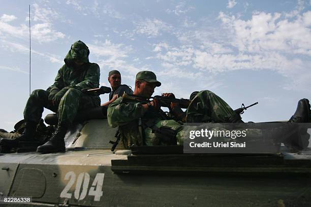 Russian soldiers sit atop their armoured vehicles, August 13, 2008 near Orjosani on the main road between Gori and Tblisi in Georgia. Russia has...