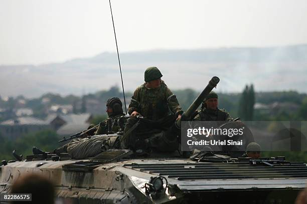 Russian soldiers sit atop their armoured vehicles, August 13, 2008 near Orjosani on the main road between Gori and Tblisi in Georgia. Russia has...