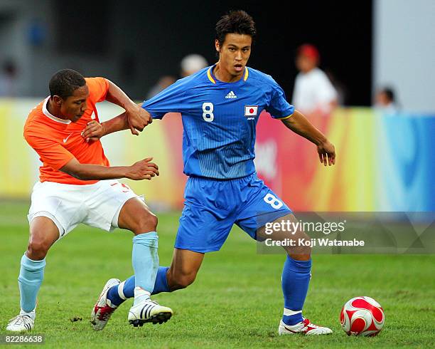 Keisuke Honda of Japan and Jonathan De Guzman of the Netherlands compete for the ball during the Men's Group B match between Netherlands and Japan at...