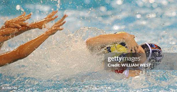 Netherlands' Lefke van Belkum keeps the ball safe from the hands of Greece's players during their women's preliminary round group B water polo match...