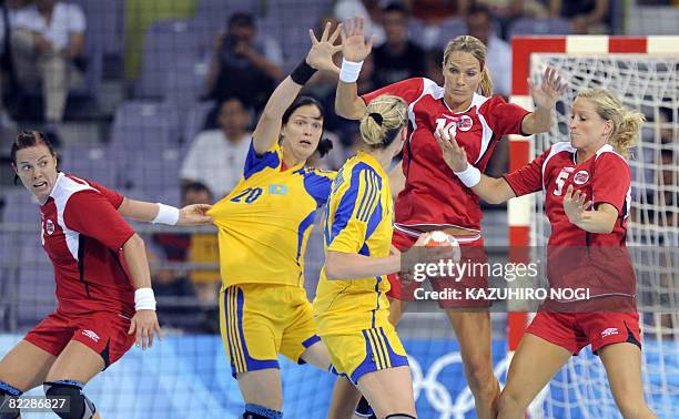 Norway's Else Marthe Soerlie Lybekk , Gro Hammerseng , and Goeril Snorroeggen vie with opponents from Kazakstan during their 2008 Beijing Olympic...