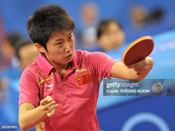 China's table tennis player Guo Yue returns a shot against Dominican's Wu Xue during the Women's Team table tennis qualification round of the 2008...
