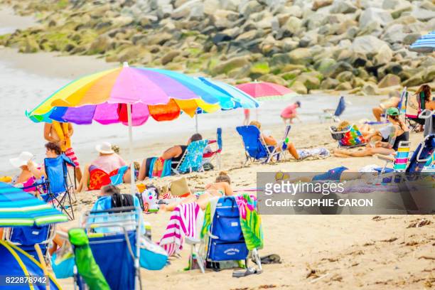 holidaymakers on the beach - équipement stock pictures, royalty-free photos & images