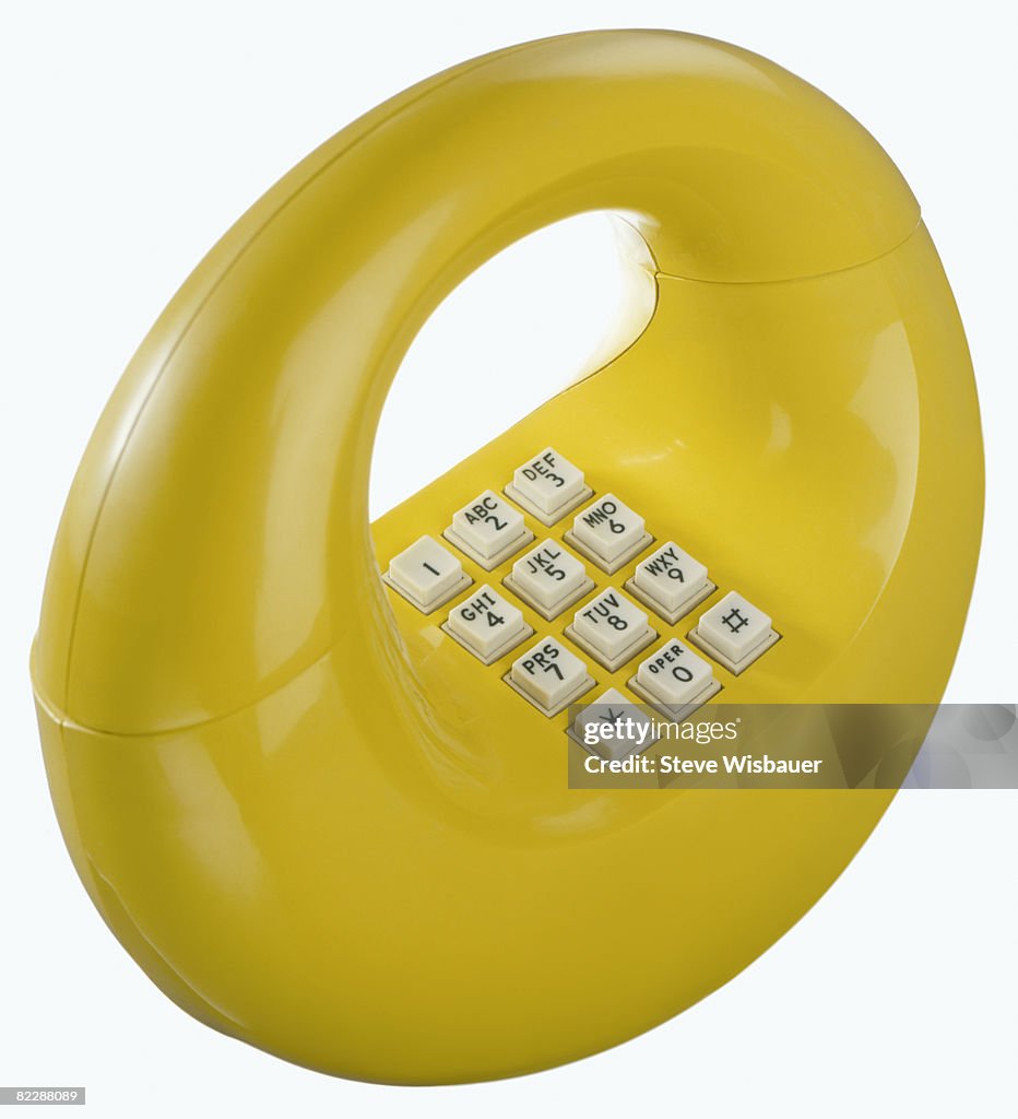 Yellow retro 1970s hoop donut or loop telephone