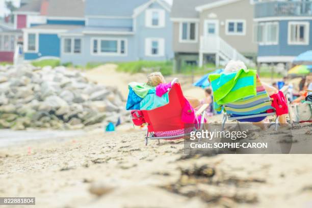 holidaymakers on the beach - équipement imagens e fotografias de stock