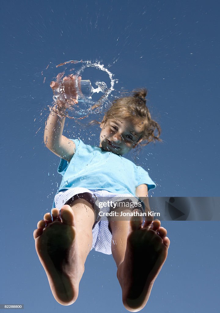 Girl pours out water from l