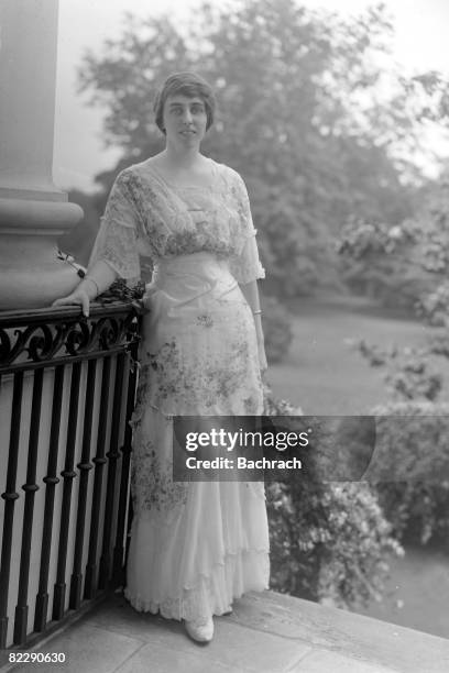 Portrait of American author Eleanor Randolph Wilson , the youngest daughter of President and Mrs. Woodrow Wilson, as she stands near some ironwork...