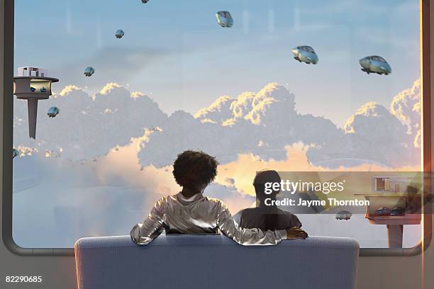 couple watching sunest outside future home window - sitting on a cloud foto e immagini stock