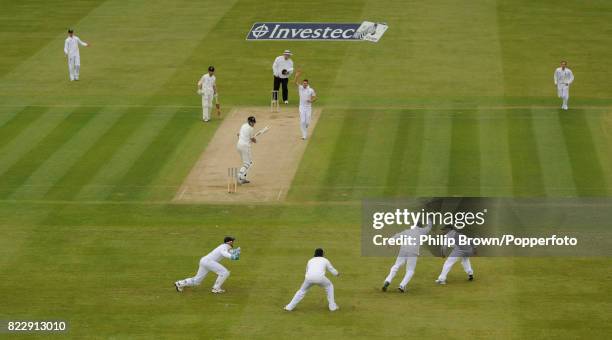 England's James Anderson celebrates his 300th Test wicket by dismissing New Zealand's opening batsman Peter Fulton, caught by Graeme Swann during the...