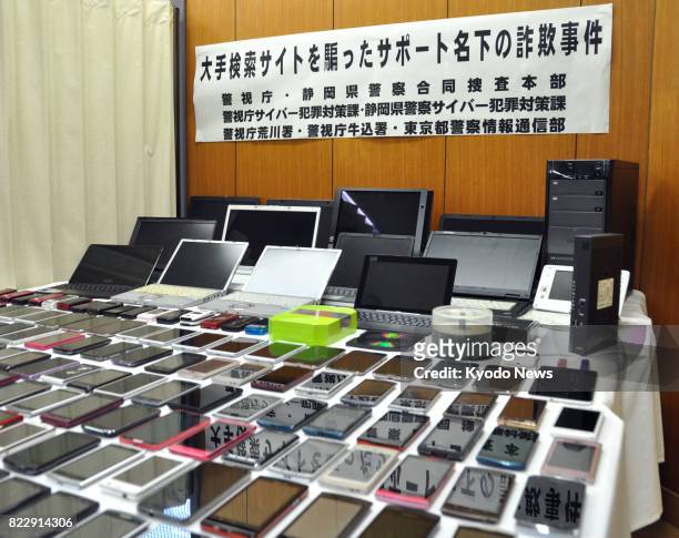 Photo taken at the Metropolitan Police Department's Arakawa station in Tokyo on July 26 shows smartphones and laptops seized for investigation. Two...