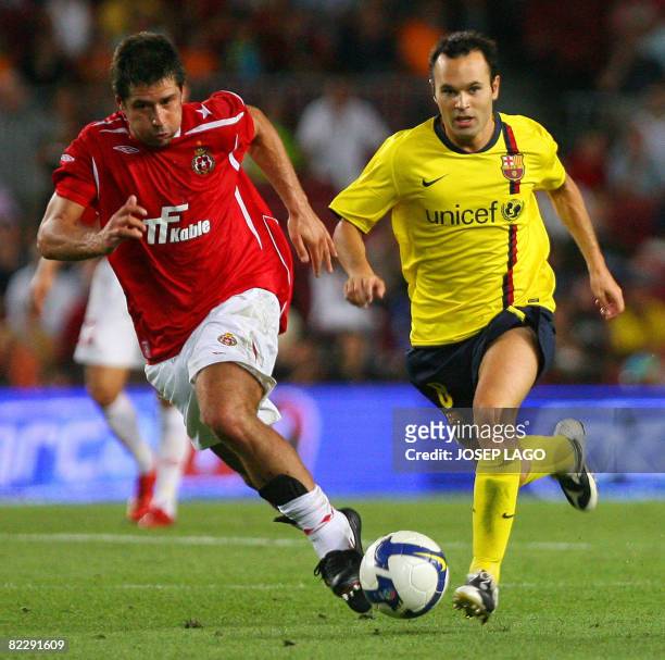 Barcelona's Andres Iniesta vies for the ball with Wisla Cracovias Mauro Cantoro during their UEFA Cup Champions League football match at the New Camp...