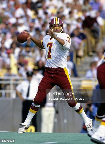Joe Theismann of the Washington Redskins goes back to pass during a NFL game against the Chicago Bears on September 28, 1985 in Chicago, Illinois.