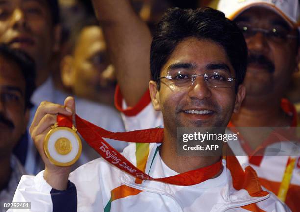Gold medal winner for the Men's 10m Air Rifle competition at the 2008 Beijing Olympic Games Abhinav Bindra show's his medal as he arrives at the...