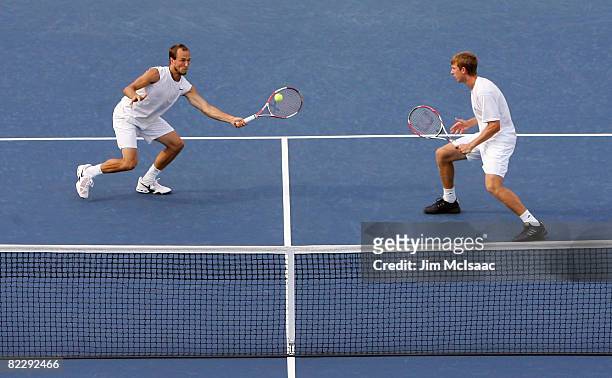 James Cerretani and Eric Butorac return a shot during their doubles match against Sonchat Ratiwatana and Sanchai Ratiwatana of Thailand during the...