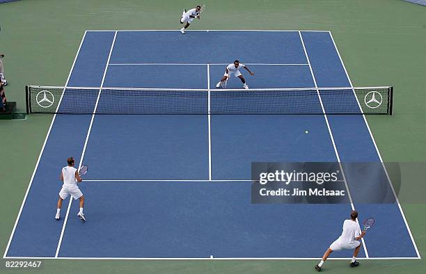 Eric Butorac and James Cerretani receive a serve during their doubles match against Sonchat Ratiwatana and Sanchai Ratiwatana of Thailand during the...