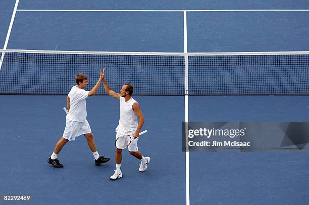 Eric Butorac and James Cerretani celebrate a point during their doubles match against Sonchat Ratiwatana and Sanchai Ratiwatana of Thailand during...