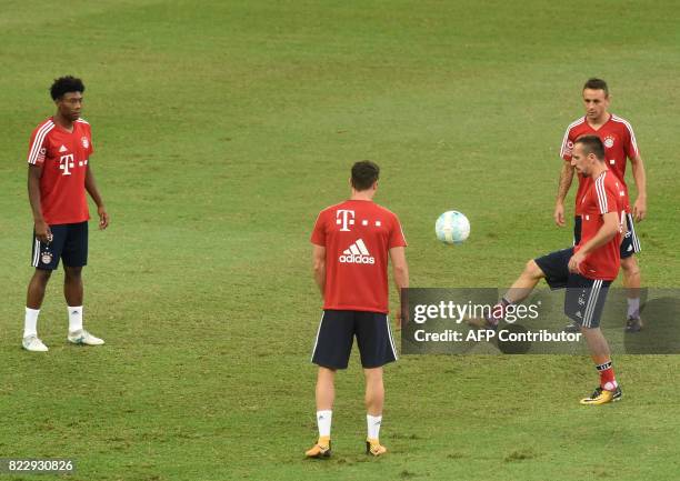 Bayern Munich's Franck Ribery warms up with teammates during their official training session in Singapore on July 26 ahead of the International...