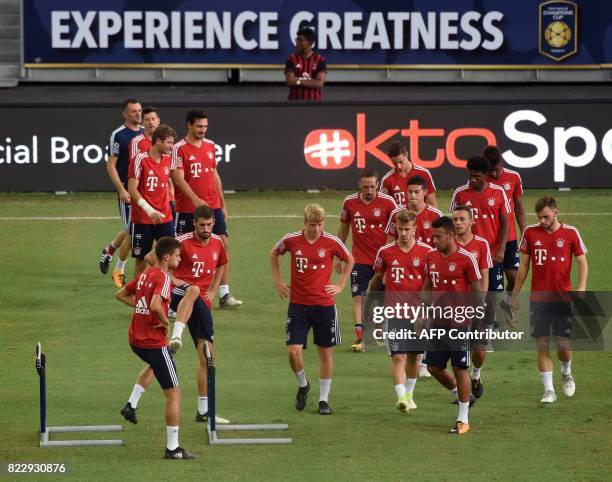 Bayern Munich players warm up during their official training session in Singapore on July 26 ahead of the International Champions Cup football match...