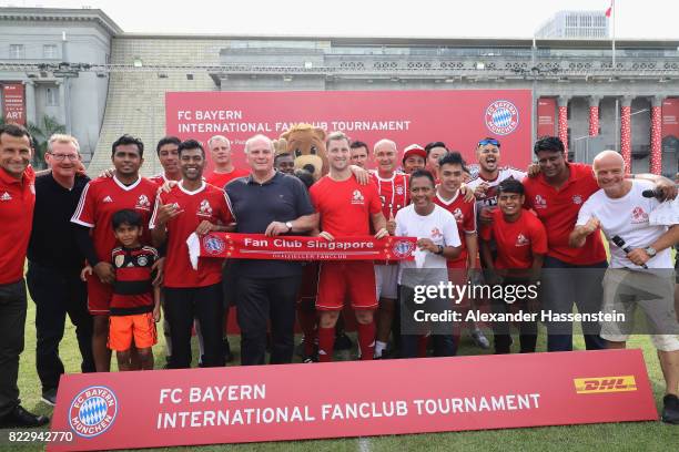 Uli Hoeness, President of FC Bayern Muenchen poses with the team of Bayern Muenchen supporters Singapore after the FC Bayern International Fanclub...