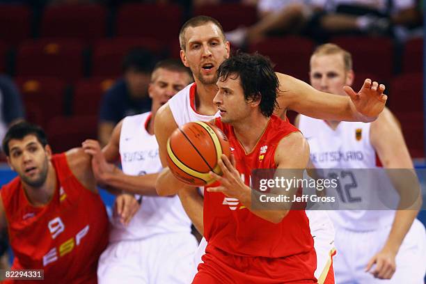 Raul Lopez of Spain is closed down by Dirk Nowitzki of Germany during the Men's Preliminary Round Group B basketball game at the Olympic Basketball...