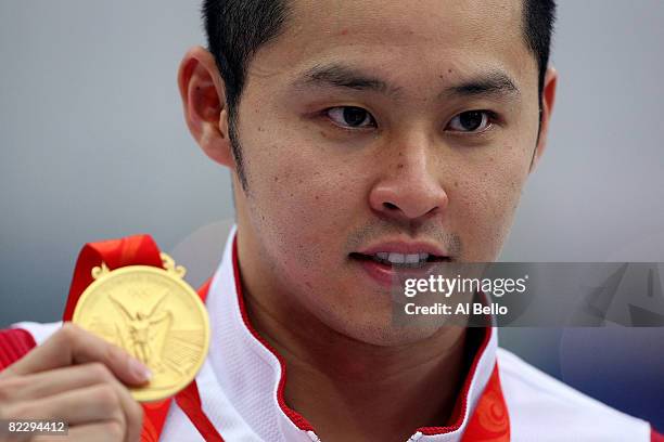 Kosuke Kitajima of Japan poses with the gold medal during the medal ceremony for the Men's 200m Breaststroke held at the National Aquatics Centre...