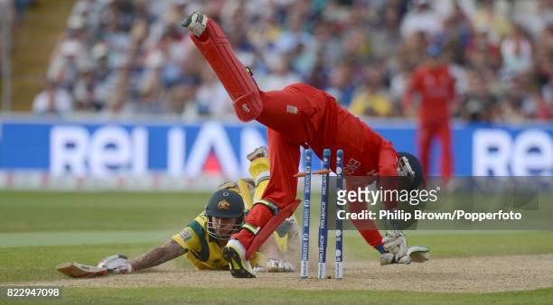 Mitchell Johnson of Australia dives to make his ground and survives a runout attempt by England wicketkeeper Jos Buttler during the ICC Champions...