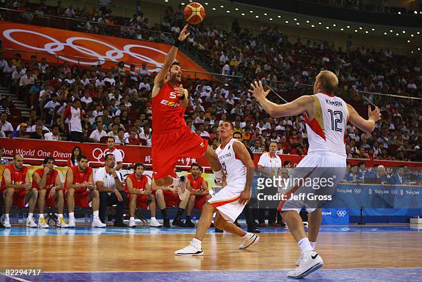 Rudy Fernandez of Spain passes the ball as Chris Kaman of Germany plays defence during the Men's Preliminary Round Group B basketball game at the...