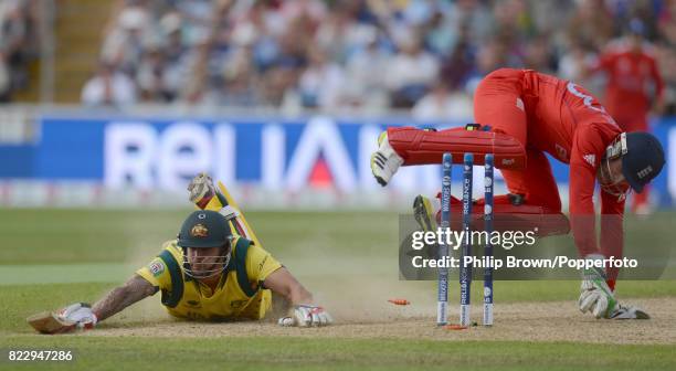 Mitchell Johnson of Australia dives to make his ground and survives a runout attempt by England wicketkeeper Jos Buttler during the ICC Champions...