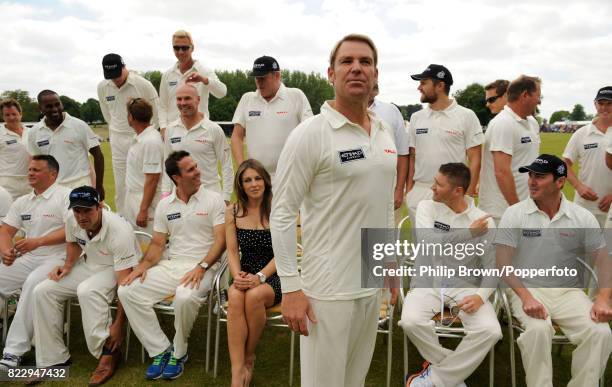 Former Australian cricketer Shane Warne waits for the teams to assemble for a group photo during a charity match between Shane Warne's Australia XI...