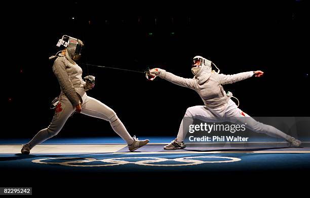 Aleksandra Socha of Poland strikes Olga Ovtchinnikova of Canada the Women's Team Sabre event at the Fencing Hall during Day 6 of the Beijing 2008...