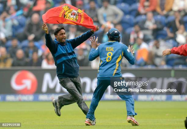 Protester runs on to the field towards Sri Lanka's Kusal Perera during the ICC Champions Trophy Semi Final between India and Sri Lanka at the Swalec...