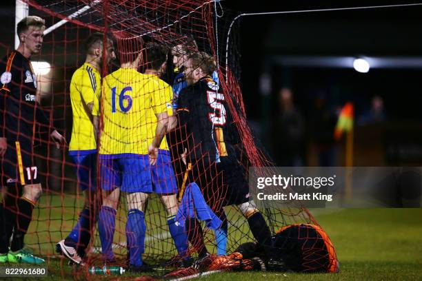 Tim Henderson of the MetroStars attempts to take the ball from Bankstown Berries goalkeeper Chad Taylor after the goal to Matthew Dawber of the...