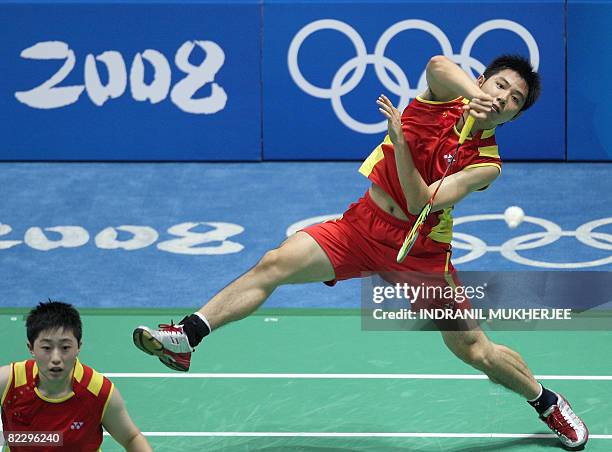 He Hanbin of China hits a return as partner Yu Yang looks on against Nadiezda Kostiuczyk and Robert Mateusiak of Poland in the mixed doubles...