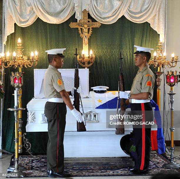 Honour guards are posted beside the flag draped coffin of Philippine Marine Corporal Angelo Abeto at a funeral wake in Marine headquarters in Manila...