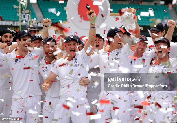 England captain Andrew Strauss holds up a replica of the Ashes urn at the Sydney Cricket Ground after England won the 5th Test match between...