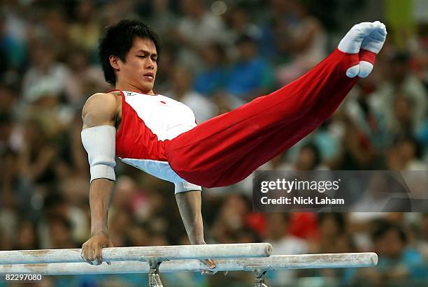 Hiroyuki Tomita of Japan competes in the parallel bars during the men's individual all-around artistic gymnastics final at the National Indoor...