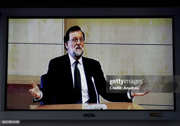 Spanish Prime Minister, Mariano Rajoy is seen on the screen as he takes the witness stand on Gurtel Case at Court House in Madrid, Spain on July 26,...