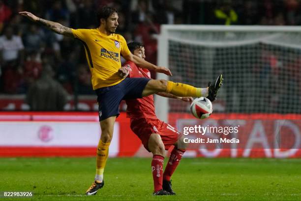 Sime Vrsaljko of Atletico de Madrid fights for the ball with Rubens Sambueza during a friendly match between Toluca and Atletico de Madrid as part of...