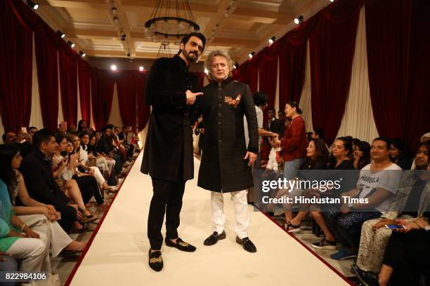 Bollywood actor Arjun Rampal with designer Rohit Bal showcasing the couture collection of designer Rohit Bal during the first day of India Couture...