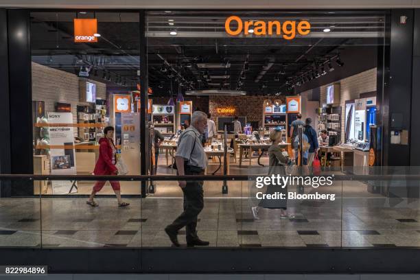 Pedestrians pass an Orange SA mobile phone store in Blagnac near Toulouse, France, on Wednesday, July 26, 2017. Orange is looking for European...