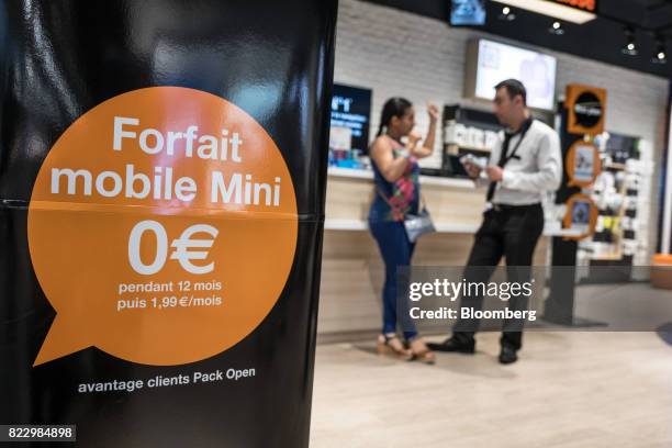 Mobile phone package advertisement sign sits inside an Orange SA store in Blagnac near Toulouse, France, on Wednesday, July 26, 2017. Orange is...