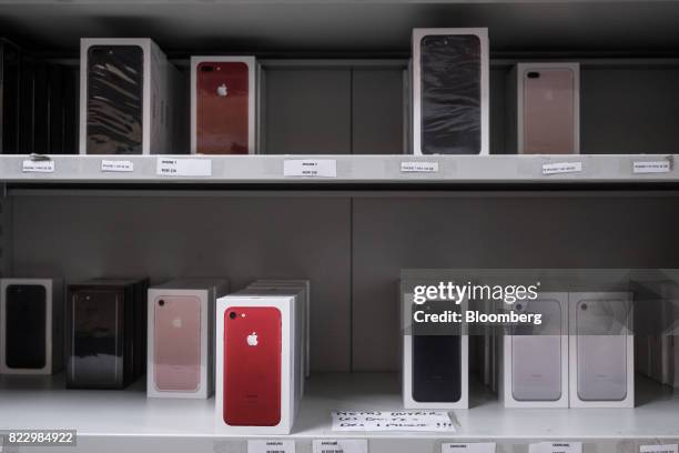 Boxes of Apple Inc. IPhone 7 smartphones sit at the storeroom inside an Orange SA mobile phone store in Blagnac near Toulouse, France, on Wednesday,...