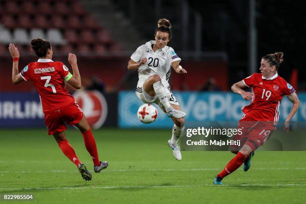 Anna Kozhnikova of Russia , Lina Magull of Germany and Ekaterina Morozova of Russia battle for the ball during the Group B match between Russia and...